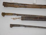 three different types of weapons are displayed on a white surface