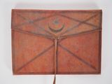 an old leather book with a star and crescent design on it