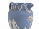 a blue vase with a picture of a man and a woman on it