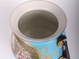 a blue and gold vase with a handle on a white background