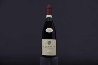 a bottle of wine sitting on top of a wooden table
