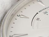a close up of a watch face with a white cloth