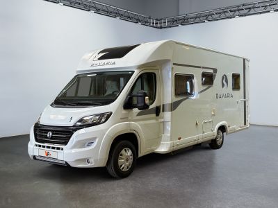an image of a white motorhome parked in a garage