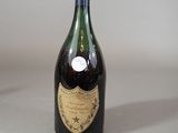 an old bottle of wine sitting on a table with a label on it