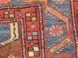 an old persian rug with a red and blue design