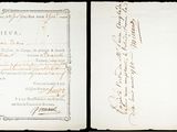 an old document with writing on it sitting on top of a table