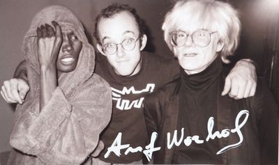 black and white photograph of three men in hoodies posing for a picture