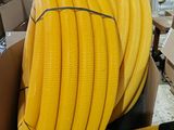 a box with a bunch of yellow hoses in it