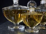 three bottles of perfume sitting next to each other on a table