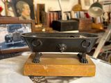 a black and gold bath tub sitting on top of a white counter