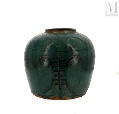 a green vase with a ladder on it on a white surface