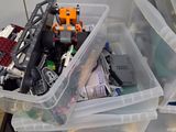 many plastic containers with legos in them on a table
