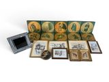 an assortment of framed and unframed art pieces including a couch, picture frames, and a picture frame