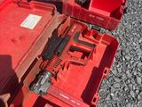 a red tool box with a gun inside of it