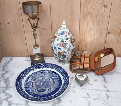 a blue and white plate on a table next to a blue and white plate