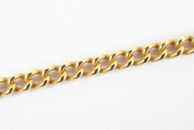 a close up of a gold chain on a white surface