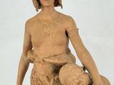 a statue of a man holding a hat and a bowl