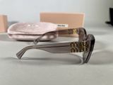 chanel sunglasses with box and case on table in front of them