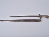 an old pair of knives sitting next to each other on a white surface
