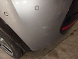 a close up of a car ' s bumper with a hole in it