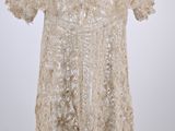 a white dress on a hanger with a white background