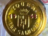 a gold coin sitting on top of a table next to a pair of scissors