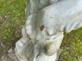 a close up of a statue of a person holding a bird