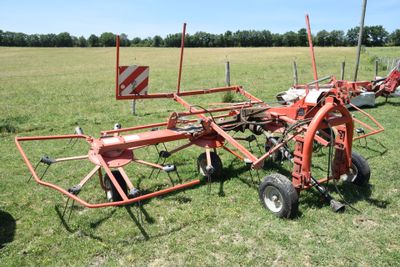 a tractor with a plow attached to it in a field