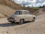 a old car that is parked on the side of the road