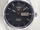 a close up of a watch on a white surface
