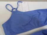 the top of a blue bra top with a pair of scissors on it