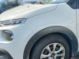 a white car that is parked on the side of the road