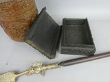 a small wooden box with a metal handle next to a small wooden box with a metal handle