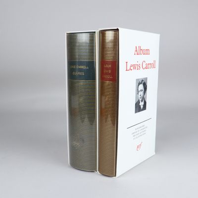two books sitting on top of each other on a white surface