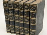 six black books with gold trims are stacked on top of each other