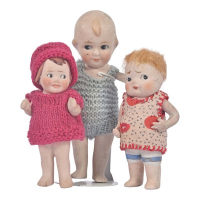 three little dolls that are standing next to each other