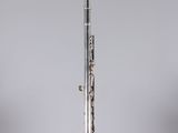 an old silver flute sitting on top of a clear box