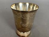 a silver cup that is sitting on a table