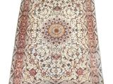 a beige and red rug with a medallion design on it