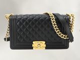 a black chanel bag with a gold chain strap