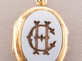a close up of a gold and white locke with the letter d on it