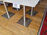 three tables with a red umbrella on them in a store