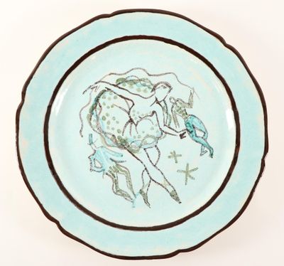 a blue plate with a drawing of a woman on a horse
