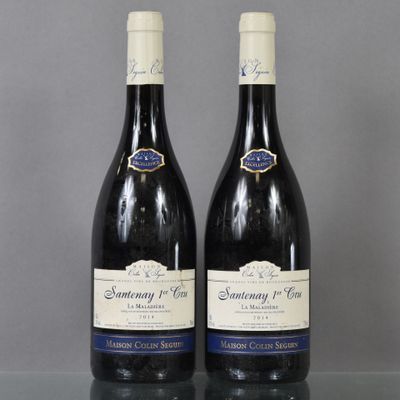 two bottles of wine sitting on top of a table next to each other