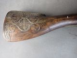 a wooden paddle that has a decorative design on it