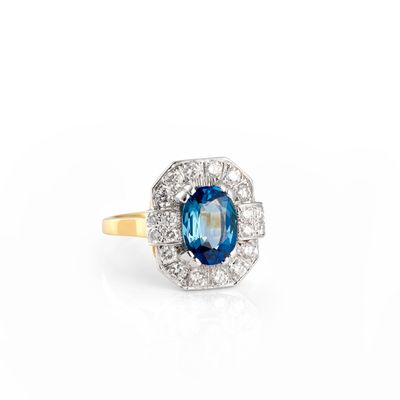 a close up of a blue and white diamond ring