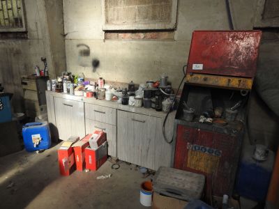 a kitchen with a lot of clutter on the counter