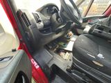 a red car with a black seat and steering wheel
