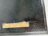 a black metal box with a yellow label on it