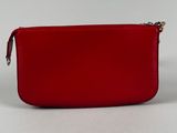 a red purse sitting on top of a white table